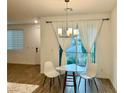 Cozy dining area with stylish table set near sliding glass doors and white curtains at 965 Nevada State Dr # 39102, Henderson, NV 89002