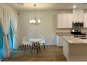 Bright kitchen and dining space, featuring white cabinets, granite counters, and modern appliances at 965 Nevada State Dr # 39102, Henderson, NV 89002