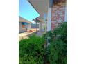 Charming exterior showcases lush greenery, a brick column, and a glimpse of the property's outdoor space at , Las Vegas, NV 89122
