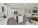 Open kitchen with white cabinets, stainless steel appliances, and a large island at 10270 Turkish Pine Ct, Las Vegas, NV 89166