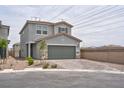View of a two-story home with a two-car garage and a brick paver driveway, located in a suburban neighborhood at 10292 Fragrant Apple Ct, Las Vegas, NV 89141