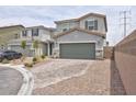 Two-story home with gray stucco, two-car garage and brick paver driveway in a suburban neighborhood at 10292 Fragrant Apple Ct, Las Vegas, NV 89141