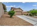 Charming single-Gathering home with desert landscaping, a two-car garage, and a concrete driveway at 10952 Napa Ridge Dr, Las Vegas, NV 89144
