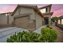 Charming two-story home features a two car garage, neutral colored stucco, and desert landscaping at 10952 Napa Ridge Dr, Las Vegas, NV 89144