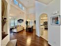 Bright and airy living room featuring hardwood floors and vaulted ceilings, flowing into the kitchen at 1704 Cordoba Canyon St, Las Vegas, NV 89117