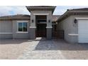 Inviting entryway with tiled walkway, arched entrance, dual lanterns and gated entry at 197 E Shelbourne Ave, Las Vegas, NV 89123