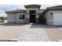 Inviting single-story home featuring a tiled walkway, arched entrance, dual lanterns and gated entry at 197 E Shelbourne Ave, Las Vegas, NV 89123