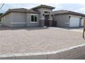 Charming single-story home featuring a gray exterior, gated entry and desert landscaping at 197 E Shelbourne Ave, Las Vegas, NV 89123