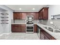 Modern kitchen with stainless steel appliances, granite countertops, and tile backsplash at 2062 Club Crest Way, Henderson, NV 89014