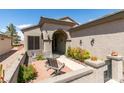 Private courtyard offers a tranquil outdoor space with a dining set, charming desert landscaping, and gated entry at 2120 Desert Woods Dr, Henderson, NV 89012