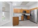 Bright kitchen featuring stainless steel appliances, wooden cabinets, and ample counter space at 3157 Capetown Way, Las Vegas, NV 89128