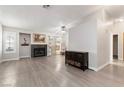Open living room with a fireplace, sliding glass doors to the backyard, and neutral colors at 3157 Capetown Way, Las Vegas, NV 89128