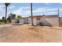 Modest single-story home with a fenced front yard and desert landscaping at 3200 E Owens Ave, North Las Vegas, NV 89030