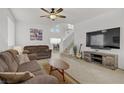 Inviting living room with neutral tones, a ceiling fan, and ample space for comfortable seating at 3205 Rainmaker St, Las Vegas, NV 89129