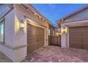 Attached two-car garage with beautiful brick-paved driveway and desert landscaping, offering a blend of style and convenience at 326 Beethoven Ridge Dr, Henderson, NV 89011