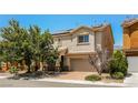 Inviting two-story home with a brick driveway and mature landscaping at 3820 Alpine Track Ave, North Las Vegas, NV 89032