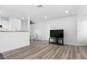 Bright living room featuring modern flooring, dining area, and mounted television at 3923 Gogo Way # 106, Las Vegas, NV 89103