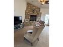 Cozy living room with a stone fireplace, comfortable seating, and natural light at 425 Ross Ave, Overton, NV 89040