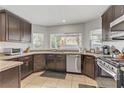 Well-equipped kitchen with sleek stainless steel appliances, ample counter space, and dark wood cabinetry at 4330 Flandes St, Las Vegas, NV 89121