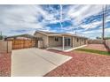 Backyard featuring a covered patio, carport, and low-maintenance gravel landscaping at 5203 Treasure Ave, Las Vegas, NV 89122