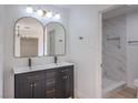 Bright bathroom with a dual sink vanity, modern fixtures, and a marble tiled walk-in shower at 5203 Treasure Ave, Las Vegas, NV 89122