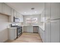 Modern kitchen featuring stainless steel appliances, white cabinets, and light countertops at 5203 Treasure Ave, Las Vegas, NV 89122
