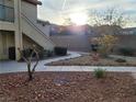 Inviting walkway leading to well maintained condo units and lush landscaping at 5710 E Tropicana Ave # 1172, Las Vegas, NV 89122