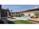 Inviting backyard featuring a sparkling pool, spa, and a cabana with an outdoor kitchen at 5855 Boulder Brook Ct, Las Vegas, NV 89149