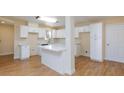 Bright kitchen features white cabinets, island with breakfast bar, and updated appliances at 6320 Shawnee Ave, Las Vegas, NV 89107