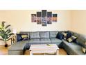 Comfortable living room with a large sectional sofa and modern decor at 6320 Shawnee Ave, Las Vegas, NV 89107
