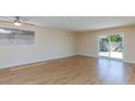 Spacious living area with ceiling fan, light walls, and sliding glass door access to the yard at 6320 Shawnee Ave, Las Vegas, NV 89107