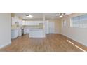 Open living room and kitchen features modern appliances, ceiling fan and wood-look flooring at 6320 Shawnee Ave, Las Vegas, NV 89107