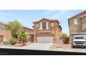 Charming two-story home featuring a two-car garage and desert landscaping in a sunny neighborhood at 6480 Chebec St, North Las Vegas, NV 89084