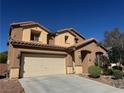 Charming two-story home features a two car garage and landscaped front yard under a clear blue sky at 6756 Sea Swallow St, North Las Vegas, NV 89084