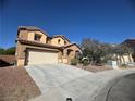 Charming two-story home features a two car garage and landscaped front yard under a clear blue sky at 6756 Sea Swallow St, North Las Vegas, NV 89084