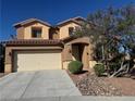 Charming two-story home features a two car garage and landscaped front yard under a clear blue sky at 6756 Sea Swallow St, North Las Vegas, NV 89084