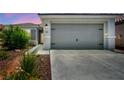 Inviting home exterior with a well-maintained two-car garage, charming curb appeal at 7029 Bocaire Dr, Las Vegas, NV 89131