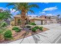 Beautiful desert home featuring a three-car garage and well-maintained landscaping at 7813 Riviera Beach Dr, Las Vegas, NV 89128