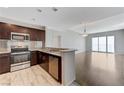 Open kitchen flows into a bright living area with wood floors and sliding glass doors at 8255 S Las Vegas Blvd # 1816, Las Vegas, NV 89123
