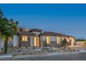Charming home exterior with a tile roof, stone accents, and well-maintained landscaping at 9 Rue Grimaldi Way, Henderson, NV 89011