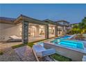 Beautiful backyard pool area with multiple pools and lounge chairs on a brick patio at 9 Rue Grimaldi Way, Henderson, NV 89011