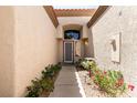 Charming entryway with a beautiful front door, desert landscaping, and a textured exterior wall at 9329 January Dr, Las Vegas, NV 89134
