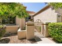 Inviting front entrance with a secure gate, desert landscaping, and a private walkway at 9329 January Dr, Las Vegas, NV 89134