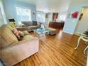 Bright living area boasts wood floors, comfortable sofas, and seamless flow to the kitchen at 11117 Okeefe Ct, Las Vegas, NV 89144