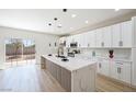 Modern kitchen with white cabinetry, a large island, and stainless steel appliances at 1312 Pacific Terrace Dr, Las Vegas, NV 89128