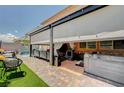 Relaxing backyard oasis with covered patio, hot tub, ample seating, and artificial turf at 1413 Miller Ridge Ave, North Las Vegas, NV 89031