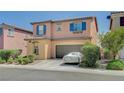 Two-story home showcasing colorful exterior, tidy landscaping, and two-car garage at 1413 Miller Ridge Ave, North Las Vegas, NV 89031