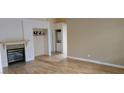 Spacious living room with hardwood floors, fireplace, and convenient washer/dryer access at 1612 N Torrey Pines Dr # 104, Las Vegas, NV 89108