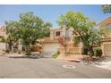 Charming two-story home with a well-maintained front yard and a two-car garage on a sunny day at 2057 Wandering Doe Ln, Las Vegas, NV 89134