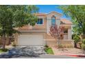 Charming two-story home with a well-maintained front yard and a two-car garage on a sunny day at 2057 Wandering Doe Ln, Las Vegas, NV 89134
